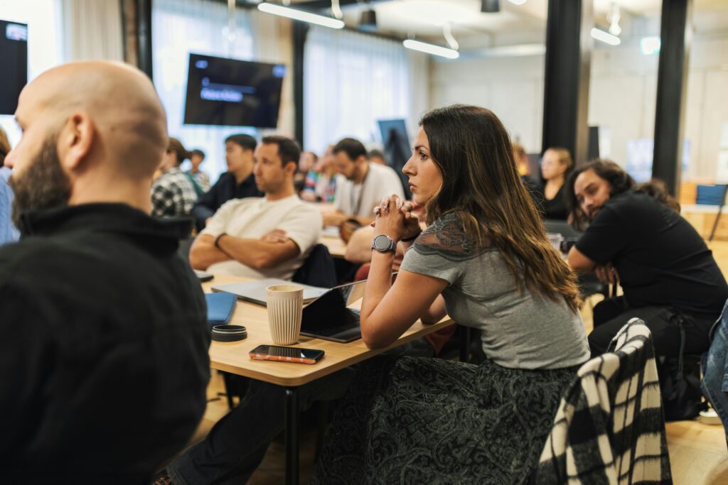 Adults engaged in a business meeting in a modern, inviting office environment.